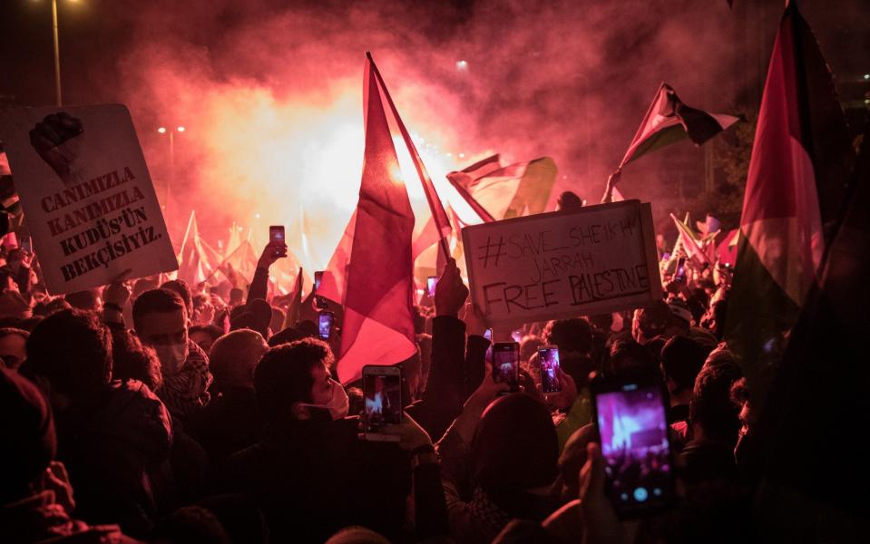 Protesters chant slogans and wave flags outside the Israeli Consulate during a protest against Israel on May 10, 2021 in Istanbul, Turkey - Getty Images Europe /Chris McGrath 