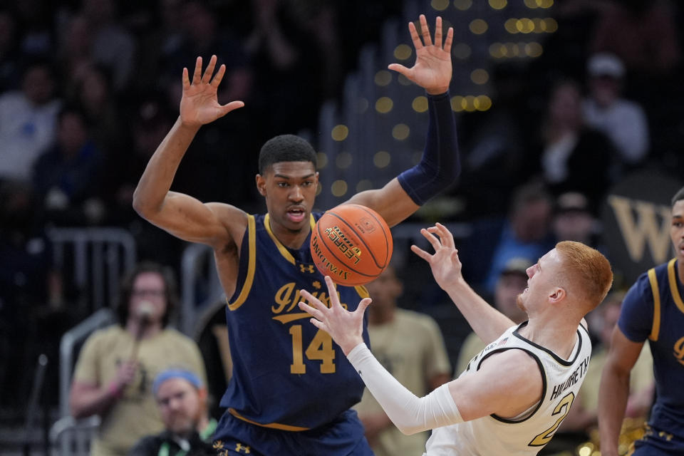 Notre Dame forward Kebba Njie (14) strips the ball from Wake Forest guard Cameron Hildreth during the second half of the Atlantic Coast Conference second round NCAA college basketball tournament game, Wednesday, March 13, 2024, in Washington. (AP Photo/Susan Walsh)