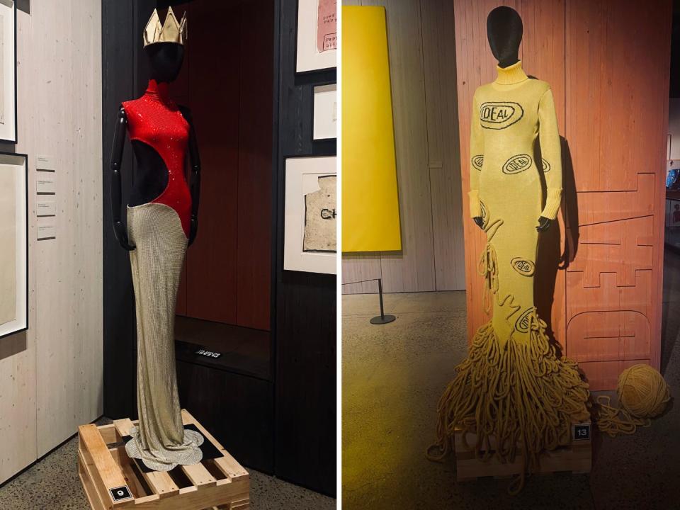 Side-by-side images of Anifa Mvuemba's gowns — a shimmery red and beige gown and a yellow knit gown — displayed at an exhibit honoring Jean-Michel Basquiat