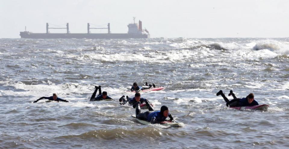 The Northern Echo: Surfboarders enjoy a freezing cold dip in the North Sea this morning (SAT) on a sunny day at