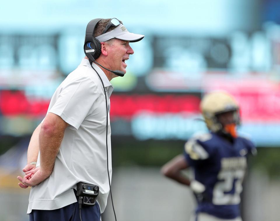 Hoban football coach Tim Tyrrell works the sideline during the second half against visiting Iona Prep on Sept. 3, 2022.