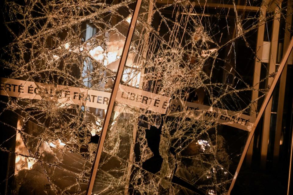 Impact marks and shattered glass are seen on the vandalized doors at the entrance of the town hall of the 4th arrondissement (district) of Lyon, France, following riots as part of a demonstration on March 17, 2023
