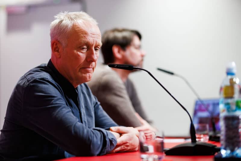 Christian Streich (L), head coach of SC Freiburg, sits during a press conference in the Europa-Park stadium. Philipp von Ditfurth/dpa