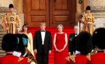 British Prime Minister Theresa May and her husband Philip stand together with U.S. President Donald Trump and first Lady Melania Trump at the entrance to Blenheim Palace, where they are attending a dinner with specially invited guests and business leaders, near Oxford, Britain, July 12, 2018. REUTERS/Kevin Lamarque