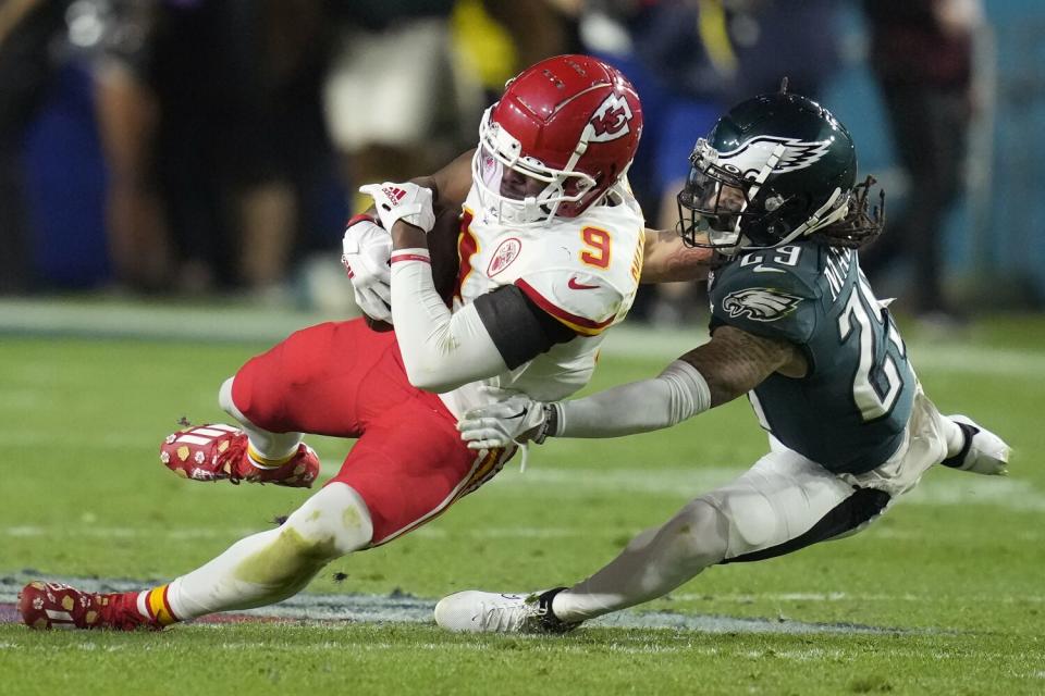 Kansas City Chiefs wide receiver JuJu Smith-Schuster falls to the turf after making a catch.