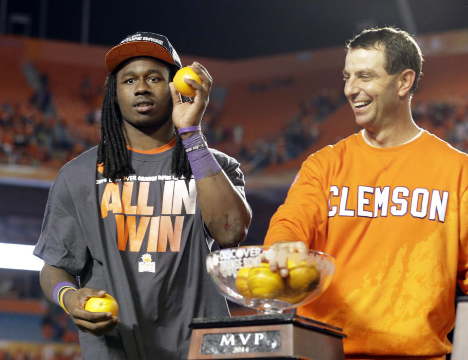 Clemson wide receiver and MVP of the game, Sammy Watkins, left, and head coach Dabo Swinney throw oranges into the crowd after Clemson defeated Ohio State 40-3 in the Orange Bowl NCAA college football game, Saturday, Jan. 4, 2014, in Miami Gardens, Fla. (AP Photo/Wilfredo Lee)