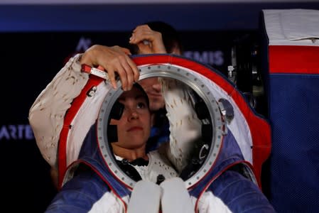 Advanced Space Suit Engineer at NASA Kristine Davis gets into the xEMU prototype space suit for the next astronaut to the moon by 2024, during its presentation at NASA headquarters in Washington