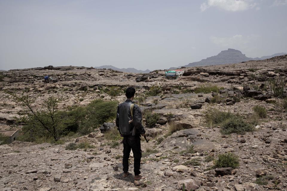 In this Monday, Aug. 5, 2019 photo, a fighter from a militia known as the Security Belt, that is funded and armed by the United Arab Emirates, stands at the frontline, in an area called Moreys, on the frontline with Houthi rebels, in Yemen's Dhale province. Yemen’s civil war has been deadlocked for months, with neither side making major gains. At one of the most active front lines, militiamen backed by the Saudi-led coalition are dug in, exchanging shelling every night with Iranian-allied Houthi rebels only a few hundred meters away. (AP Photo/Nariman El-Mofty)