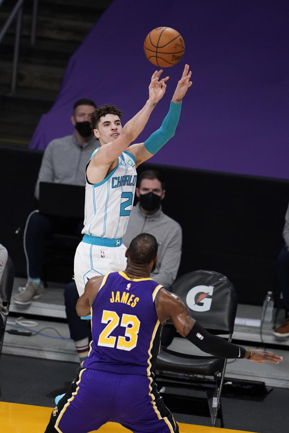 Charlotte Hornets guard LaMelo Ball shoots over Los Angeles Lakers forward LeBron James (23) during the first half of an NBA basketball game Thursday, March 18, 2021, in Los Angeles. (AP Photo/Marcio Jose Sanchez)