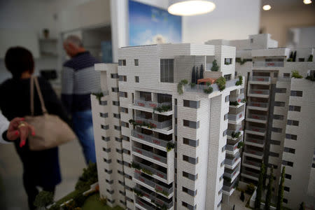 A model of new building project, called "Arnona Exclusive", is seen on display inside an exemplary flat as potential buyers walk around, in Jerusalem November 2, 2016. REUTERS/Ronen Zvulun