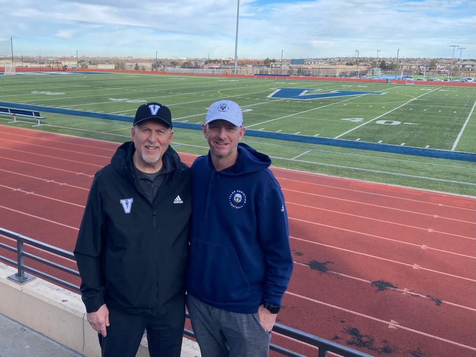 Valor football assistant coach Rex Rolf and head coach Bret McGatlin stand in front of Valor Stadium. Christian McCaffrey played for the Eagles and broke many state records in his high school career.