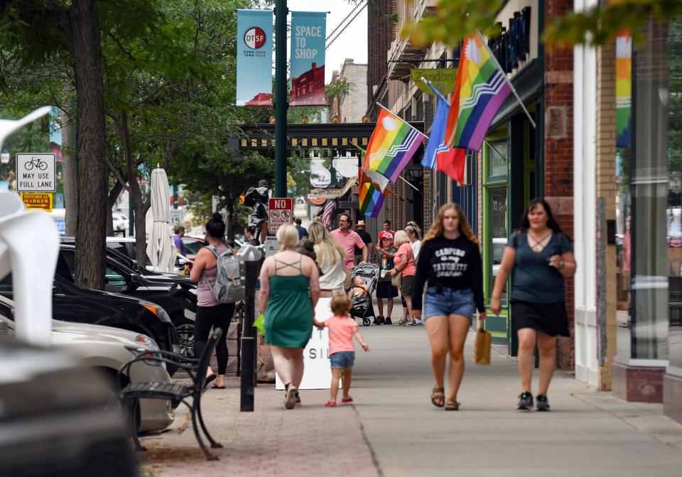 Pedestrians walk down Phillips Avenue on Wednesday, July 7, 2021, in downtown Sioux Falls.