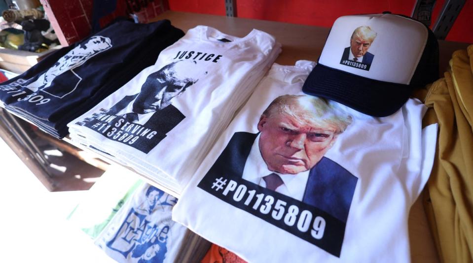 T-shirts and hats with Trump’s mug shot and booking number are pictured in Los Angeles on 26 August. (REUTERS)