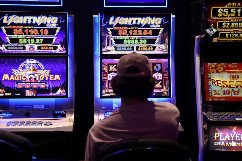 A person gambles on a poker machine at a pub in Sydney