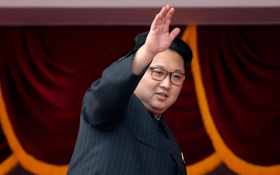 Kim Jong Un waves at parade participants at the Kim Il Sung Square in Pyongyang - Credit:  Wong Maye-E