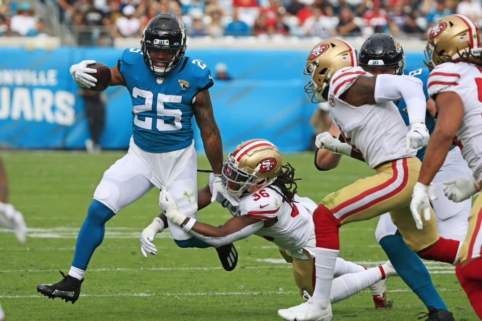 Jacksonville Jaguars running back is wrapped up by James Robinson (25) San Francisco 49ers linebacker Marcell Harris (36) during the second quarter at TIAA Bank Field Sunday, Nov. 21, 2021 in Jacksonville. The Jacksonville Jaguars hosted the San Francisco 49ers during a regular season NFL game. [Corey Perrine/Florida Times-Union]
