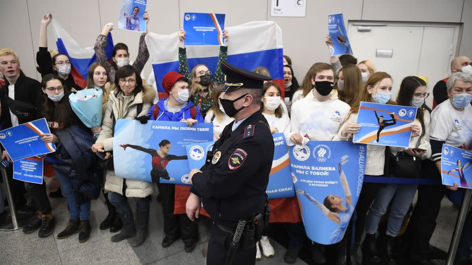 Supporters of Russia's figure skater Kamila Valieva hold posters as they wait for her arrival from China at the Sheremetevo airport outside Moscow on February 18, 2022. - Alexander Nemenov/AFP/Getty Images