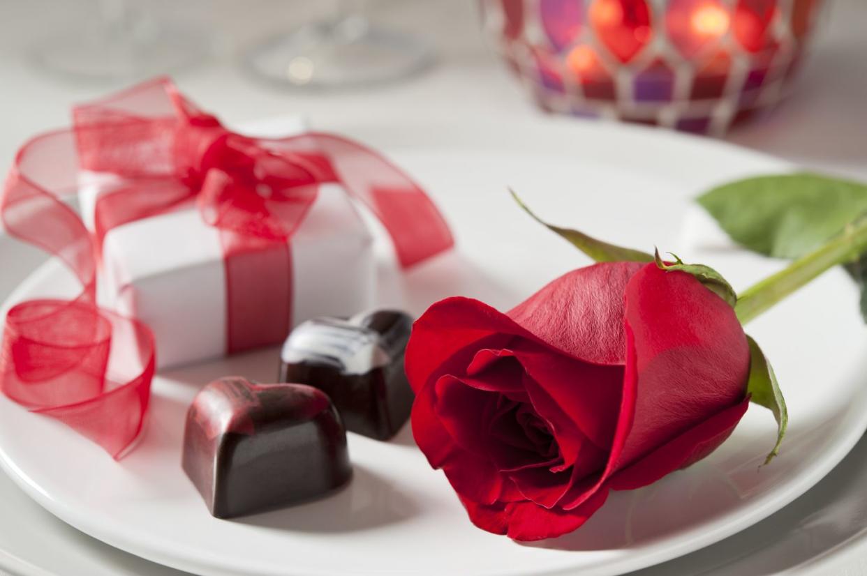 several more in this series perfect red rose, gift box, and heart shaped chocolates in a table setting very shallow dof