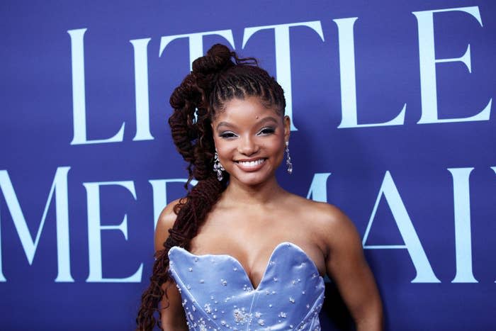 A closeup of Halle smiling on the red carpet. She's wearing a strapless dress