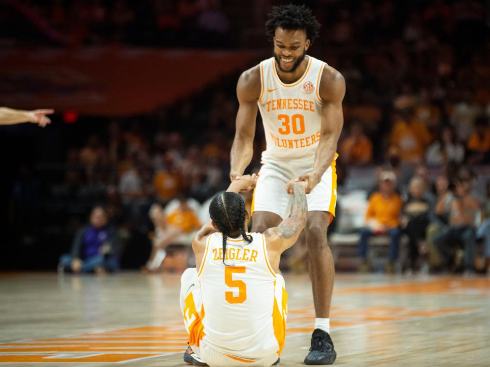 Tennessee's Josiah-Jordan James (30) helps teammate Zakai Zeigler (5) up after taking a fall during an NCAA basketball game against Tennessee Tech on Monday, November 6, 2023 in Knoxville, Tenn.