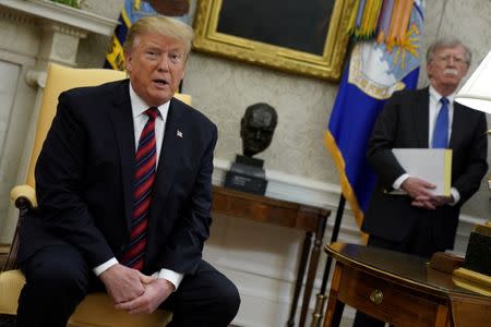 U.S. President Donald Trump speaks to reporters with National Security Adviser John Bolton looking on in the Oval Office at the White House in Washington, May 3, 2019. REUTERS/Jonathan Ernst