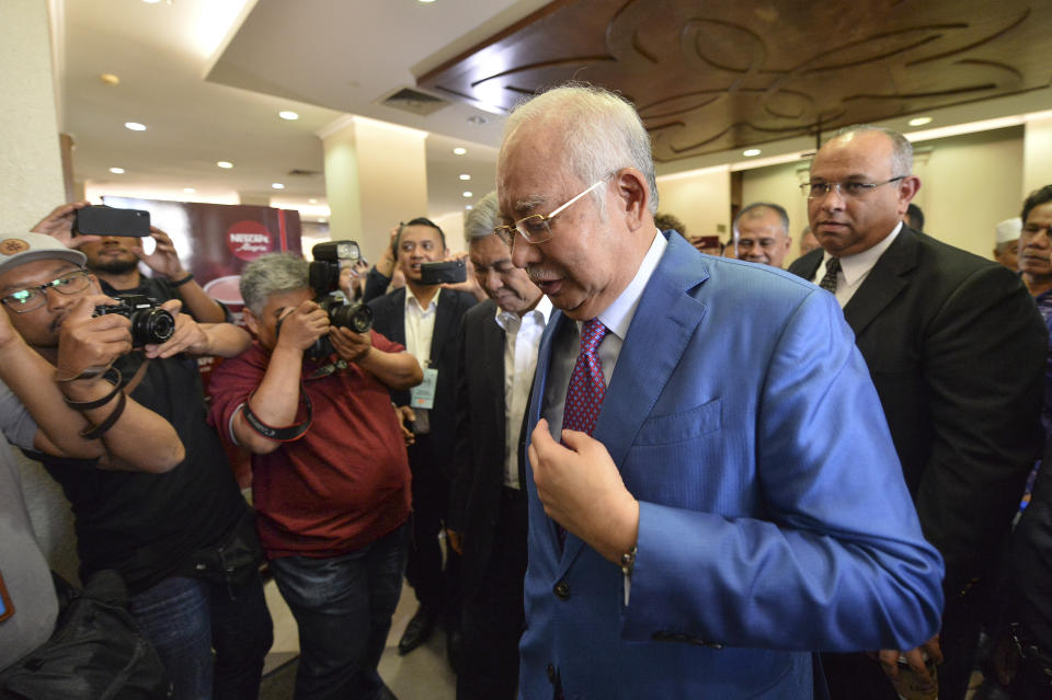 Former Malaysian Prime Minister Najib Razak, center, walks out from the courtroom at the court house in Kuala Lumpur, Malaysia for his corruption trial Tuesday, Dec. 3, 2019. Razak has started his defense Tuesday, Dec. 3, 2019, in his first corruption trial linked to the multibillion-dollar looting of the 1MDB state investment fund, that helped led to his downfall last year. (AP Photo)