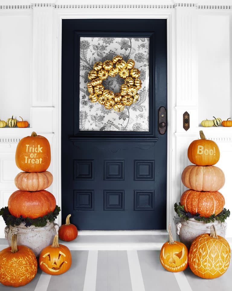 <p>You don't have to make intricate carvings to create a cute pumpkin display. Wow visitors by piling heirloom pumpkins on top of a stylish planter. </p><p><strong>RELATED:</strong> <a href="https://www.goodhousekeeping.com/holidays/halloween-ideas/g1714/no-carve-pumpkin-decorating/" rel="nofollow noopener" target="_blank" data-ylk="slk:No-Carve Pumpkin Decorating Ideas to Fill Your Halloween With Fun;elm:context_link;itc:0;sec:content-canvas" class="link ">No-Carve Pumpkin Decorating Ideas to Fill Your Halloween With Fun</a></p>