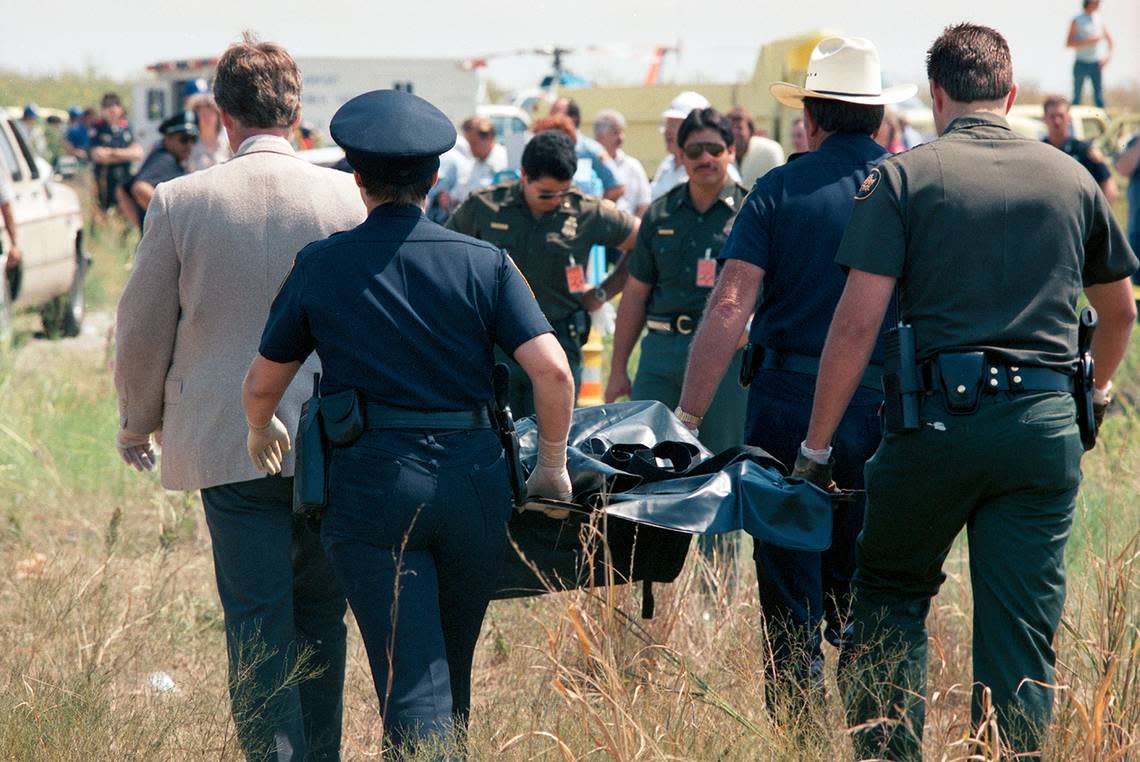 Aug. 31, 1988: Emergency personnel carry a victim of Delta 1141 from the wreckage at Dallas-Fort Worth International Airport. Injured survivors were taken to nearby HEB Hospital while the dead were moved into a makeshift morgue set up on site by the Tarrant County Medical Examiner’s Office.