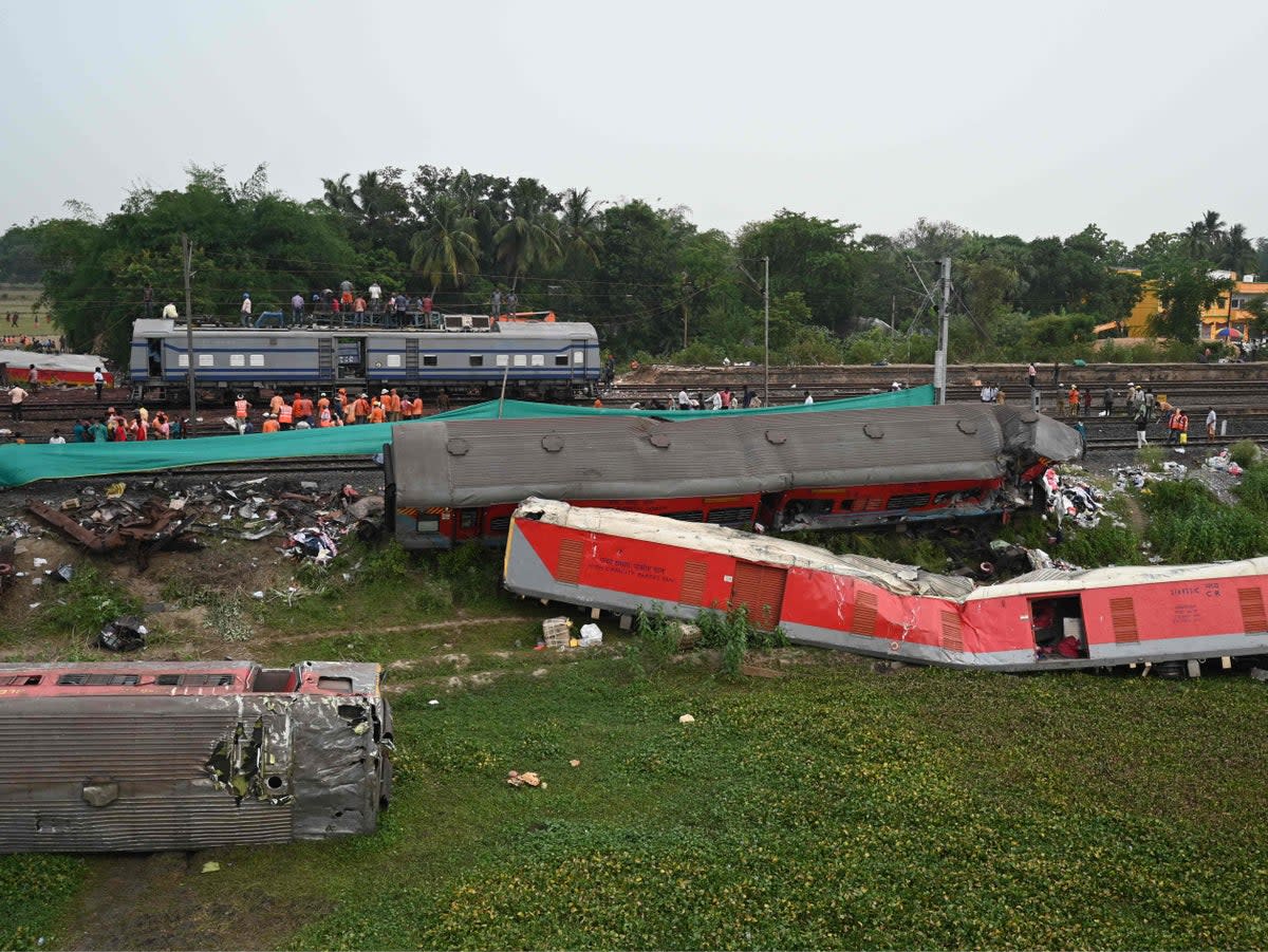 Railway workers clear the wreckage on Sunday (AFP)