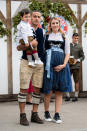 Thiago kam mit Söhnchen Gabriel Alcantara und seiner schwangeren Frau Julia Vigas, die trendgemäß zum traditionellen Dirndl in Blau eine weiße hochgeknöpfte Spitzenbluse trug. Dass sie Sneakers trug, sei ihr bei der Babykugel allerdings verziehen. (Bild: dpa)