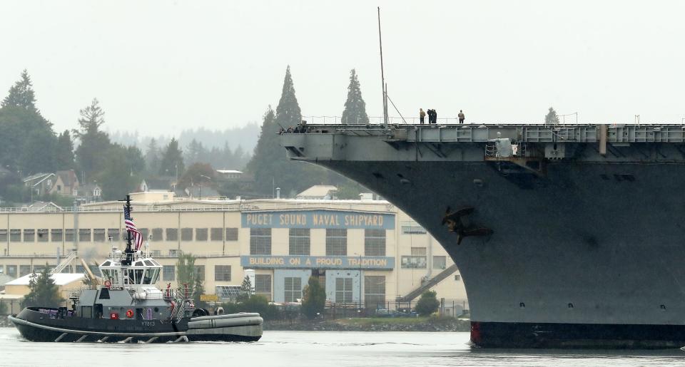 The USS Nimitz is guided past the Puget Sound Naval Shipyard by the Navy tug Sentinel as it returns to Naval Base Kitsap on Sunday, Sept. 24, 2023.
