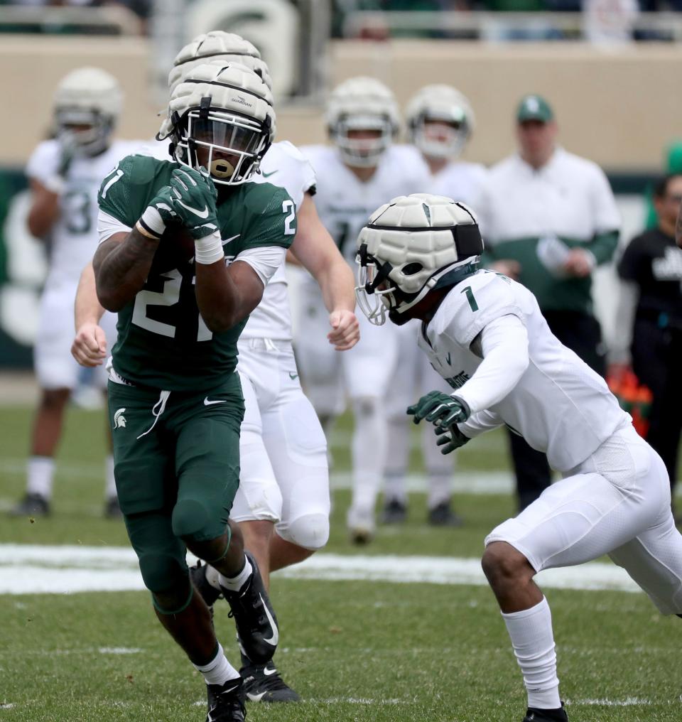 Michigan State running back Davion Primm catches a pass against defensive back Jaden Mangham during the spring practice on Saturday, April 16, 2022, at Spartan Stadium.