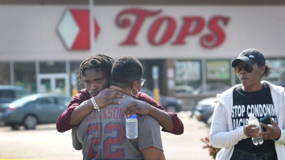 People gathered outside of Tops market embrace on May 15, 2022 in Buffalo, New York. (Photo by Scott Olson/Getty Images)