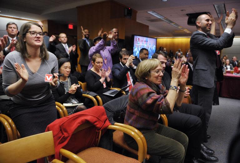 Attendees applaud after Federal Communications Commission Chairman Tom Wheeler announced the FCC ruling on net neutrality on February 26, 2015 in Washington, DC