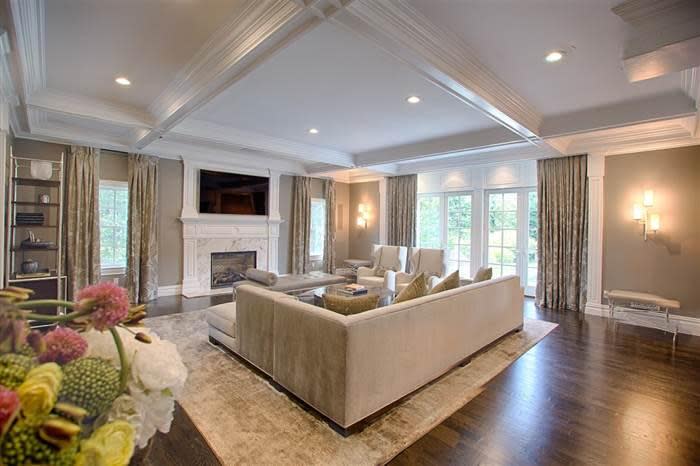 <p>The formal sitting room has a marble fire-place and flat-screen television.</p>