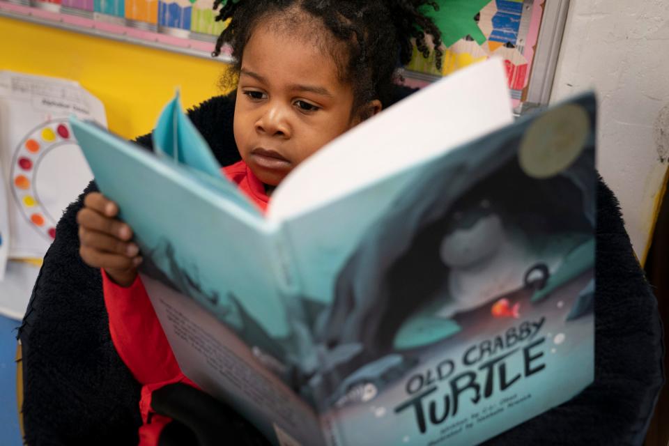 Amari Cason, 4, pages through the "Old Crabby Turtle' book as his first exercise at the School of Purpose in Detroit on Wednesday, March 20, 2024. Though Amari can't read, Tissua Franklin, the school's CEO, says it is just important for kids to have a relationship with books "know they have a cover and a back and some words they recognize," said Franklin, who is hoping to change the literacy preparation for children in Detroit. Franklin not only published a handbook to help educators and parents help their children but she has created a day care center that is focused on teaching children how to identify letters and numbers and words and to get a jump-start on reading before kindergarten.