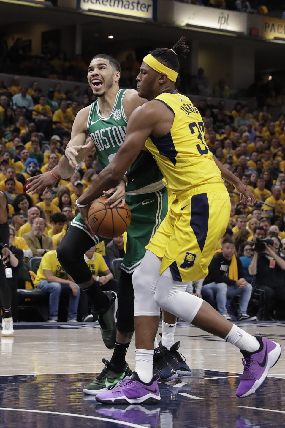 Indiana Pacers' Myles Turner (33) stripes the basketball from Boston Celtics' Jayson Tatum (0) during the second half of Game 3 of an NBA basketball first-round playoff series, Friday, April 19, 2019, in Indianapolis. Boston won 104-96. (AP Photo/Darron Cummings)