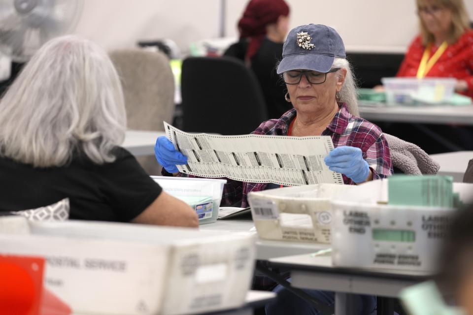 Election workers open mail-in ballots at the Maricopa County Tabulation and Election Center on Nov. 11, 2022, in Phoenix, Arizona.