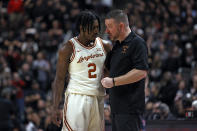 Texas coach Chris Beard talks to Marcus Carr (2) during the second half of the team's NCAA college basketball game against Texas Tech on Tuesday, Feb. 1, 2022, in Lubbock, Texas. (AP Photo/Brad Tollefson)