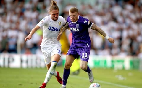 Leeds United's Luke Ayling (left) and Stoke City's James McClean battle for the ball  - Credit: PA