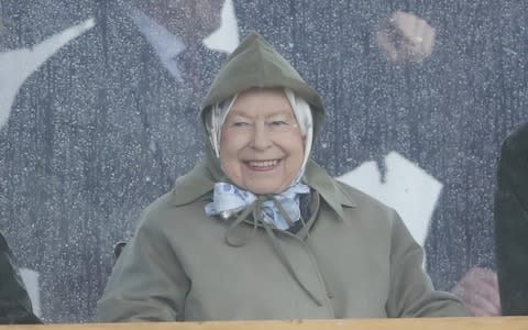 All smiles in the rain for Queen Elizabeth II - Credit: Max Mumby