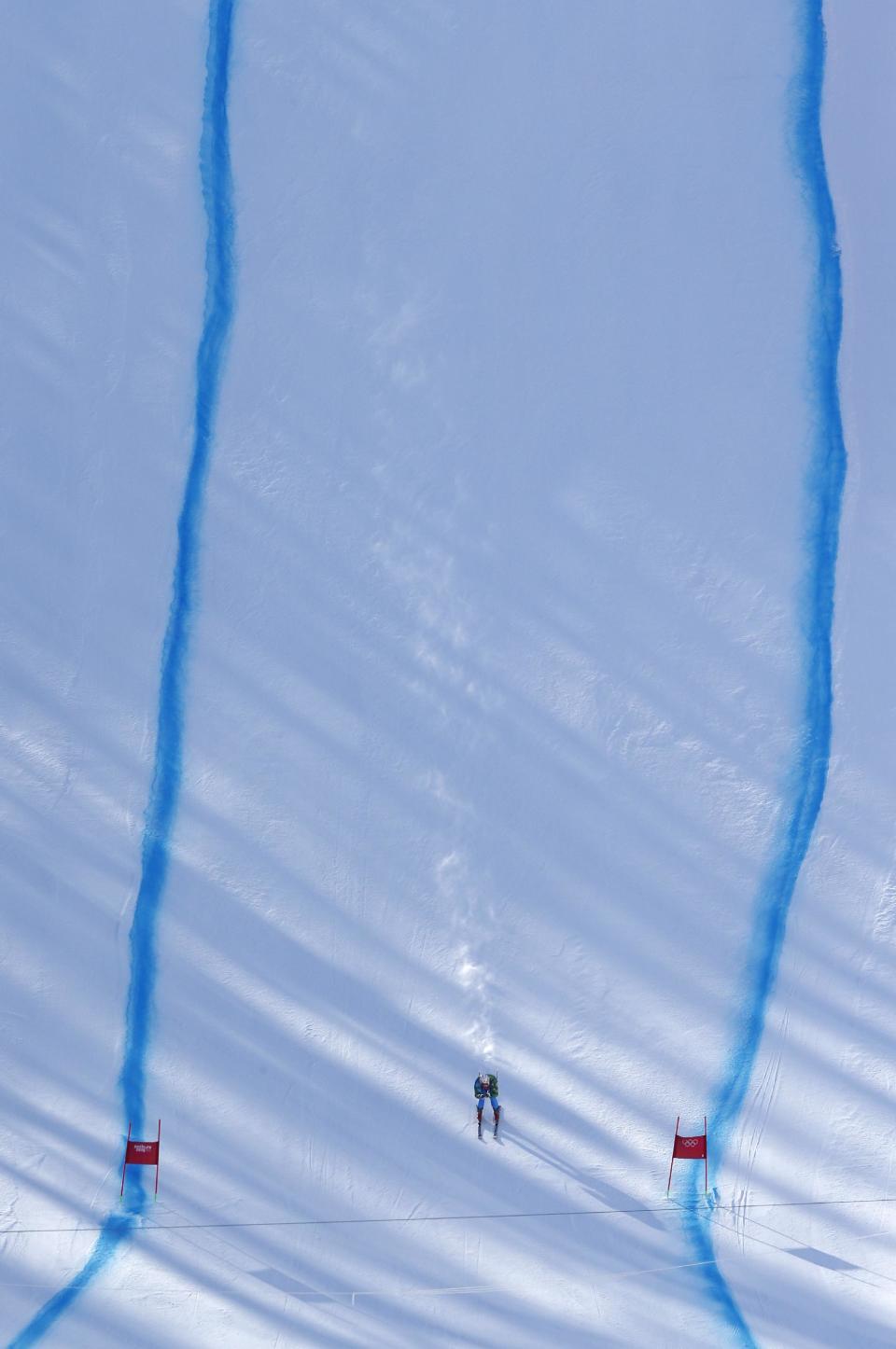 A skier speeds down the course during training ahead of the Sochi 2014 Winter Olympics, Wednesday, Feb. 5, 2014, in Krasnaya Polyana, Russia. (AP Photo/Christophe Ena)