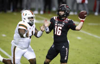 North Carolina State quarterback Bailey Hockman (16) prepares to pass while pressured by Miami defensive lineman Nesta Jade Silvera (1) during the first half of an NCAA college football game Friday, Nov. 6, 2020, in Raleigh, N.C. (Ethan Hyman/The News & Observer via AP, Pool)