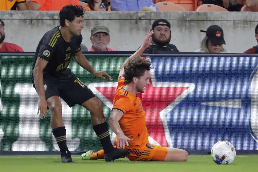 Los Angeles FC forward Carlos Vela, left, gets the kick off before the attempted slide tackle.