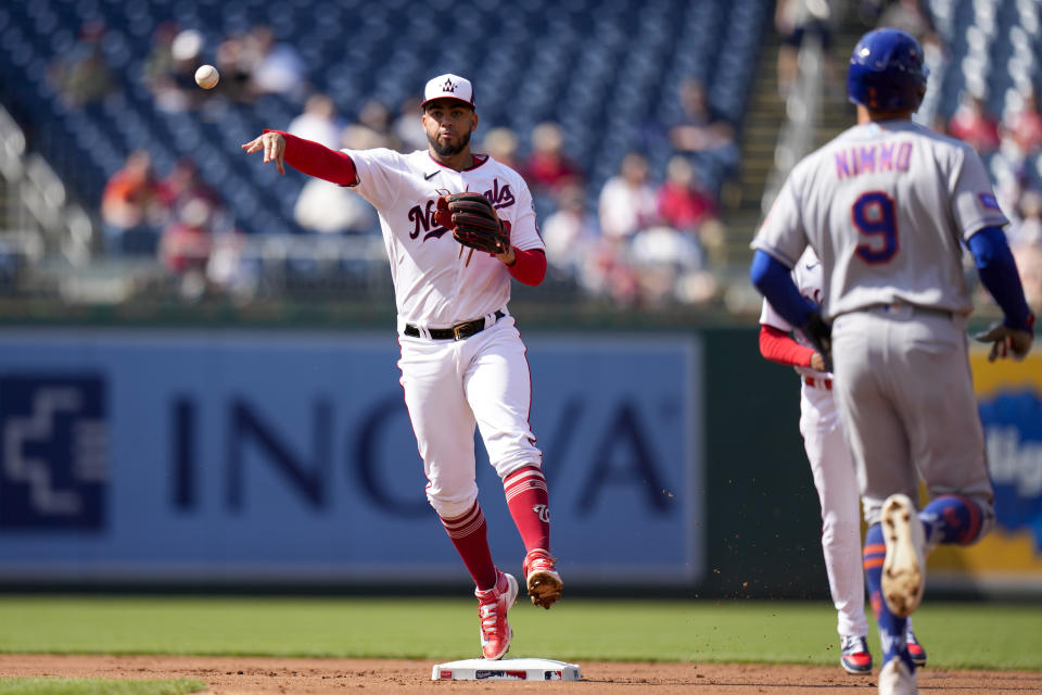 Washington Nationals second baseman Luis Garcia, left, gets an out at second base and throws to first base for a double play against New York Mets' Pete Alonso (not shown) during the first inning of a baseball game at Nationals Park, Monday, May 15, 2023, in Washington. (AP Photo/Alex Brandon)