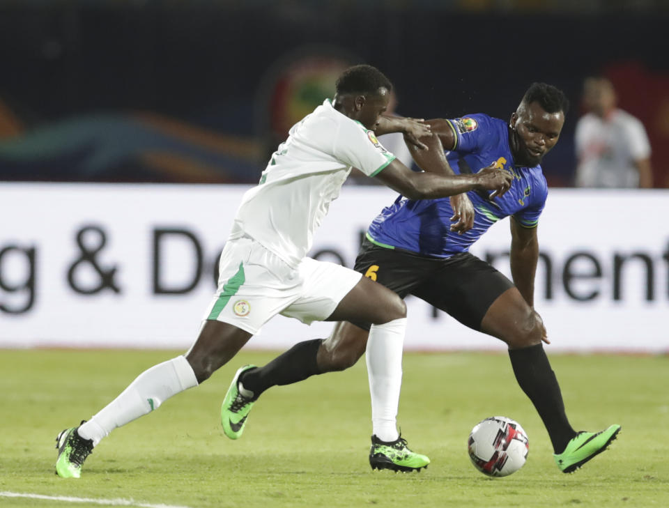 Senegal's Mbaye Hamady Niang, left, and Tanzania's Agrey Moris Ambros fight for the ball during the African Cup of Nations group C soccer match between Senegal and Tanzania at 30 June Stadium in Cairo, Egypt, Sunday, June 23, 2019. (AP Photo/Hassan Ammar)