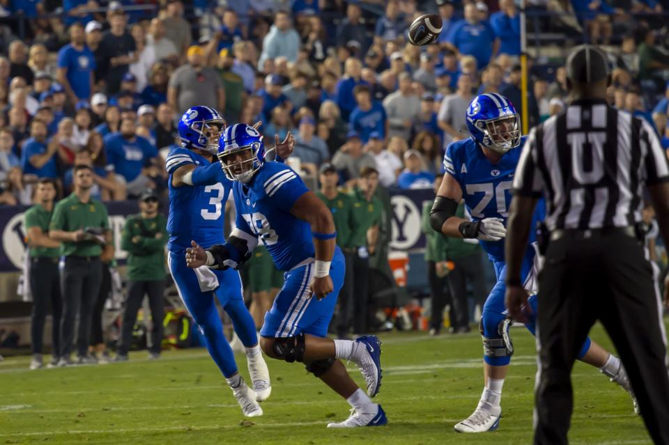 BYU quarterback Jaren Hall (3) catches the football behind offensive lineman Kingsley Suamataia (78) and Connor Pay (70) on a trick play Saturday, Sept. 10, 2022 in Provo. | Tyler Tate, Associated Press