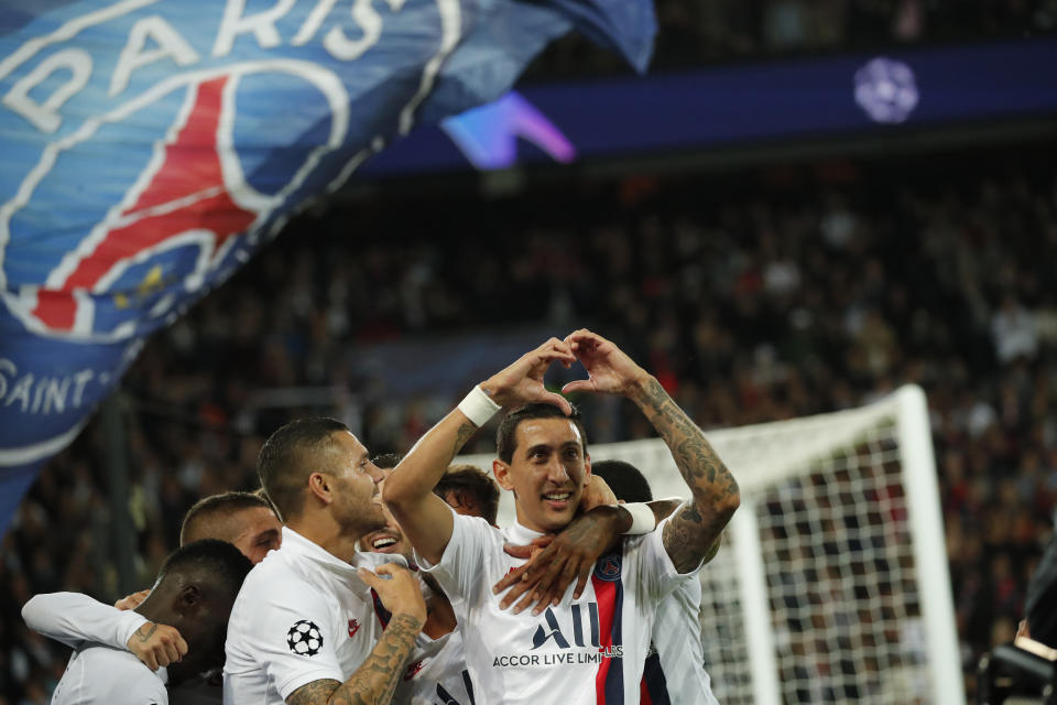 PSG's Angel Di Maria, right, celebrates after scoring his side's second goal during the Champions League group A soccer match between PSG and Real Madrid at the Parc des Princes stadium in Paris, Wednesday, Sept. 18, 2019. (AP Photo/Francois Mori)