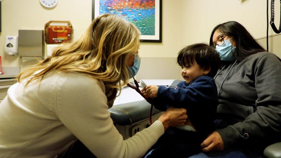 A staff member works with a child at the Holland Community Health Center.