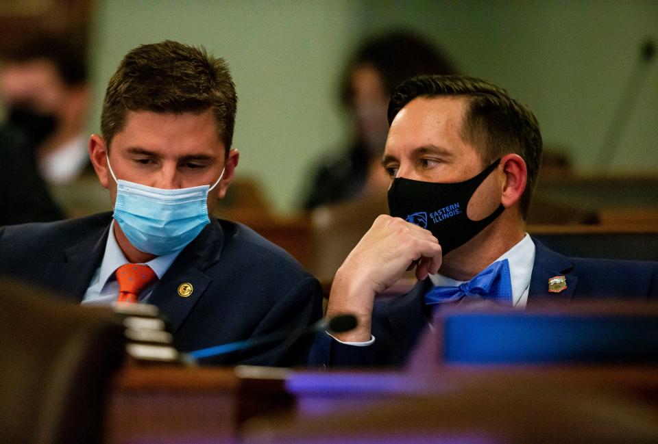 Illinois state Rep. Ryan Spain, R-Peoria, left, speaks with state Rep. Tim Butler, R-Springfield, during a public hearing May 26, 2021, at the state Capitol on the proposed boundaries for state legislative districts.